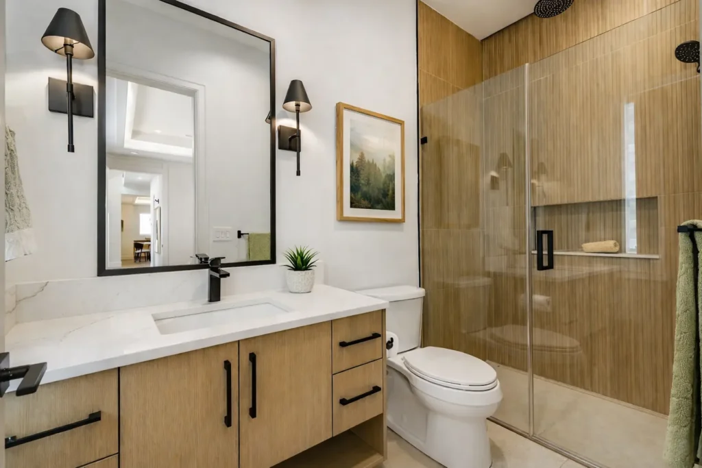 Modern Bay Area bathroom remodel featuring a wood vanity, quartz countertop, glass shower, and contemporary fixtures