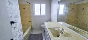 Outdated bathroom in Oakland CA with yellow tile before renovation
