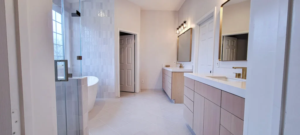 Master bathroom remodel in Pleasanton CA featuring freestanding tub, custom double vanity, quartz countertops, and brushed brass fixtures by Lions Gate Remodeling.