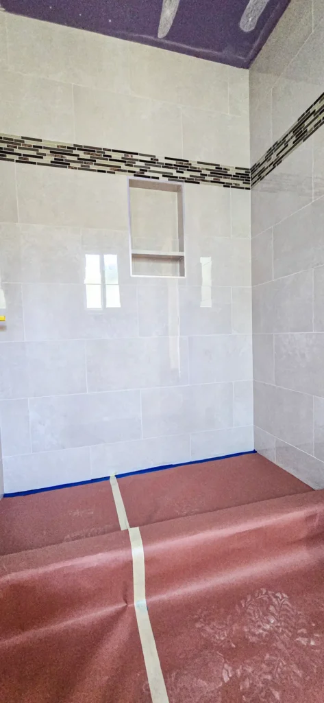 Custom shower tile installation with built-in niche during bathroom remodel in Santa Clara, California