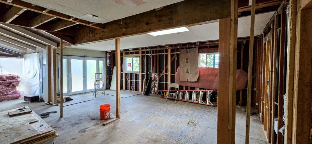 Structural wall removal during open concept home remodel in Santa Clara, California with exposed framing and ceiling beams