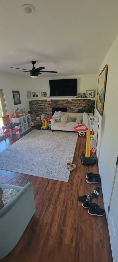 Concord CA living room before remodel with brick fireplace and older dark flooring