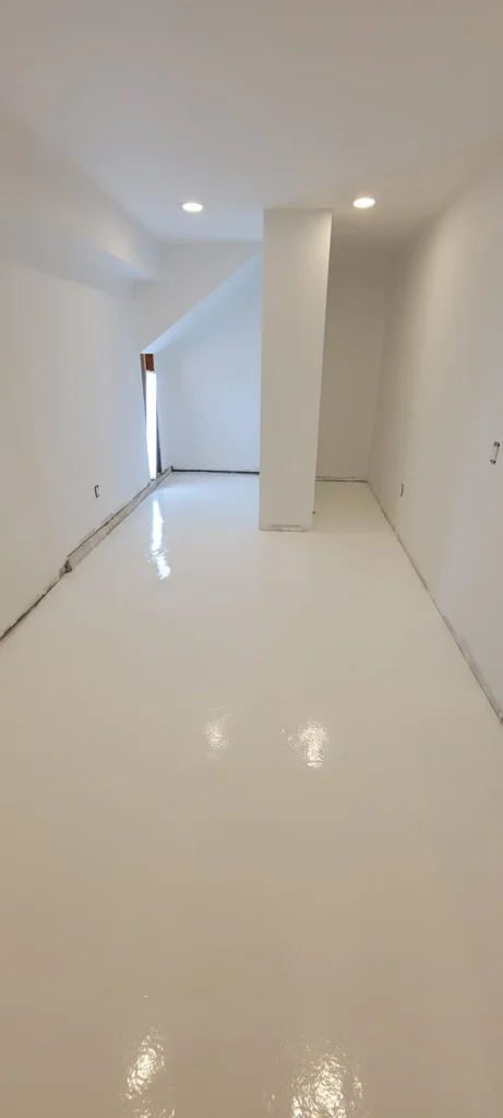 Epoxy flooring installation in progress in garage and laundry room remodel in El Sereno California