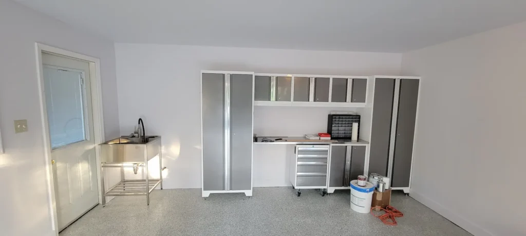 Remodeled garage and laundry area with epoxy flake flooring and storage cabinets in El Sereno California