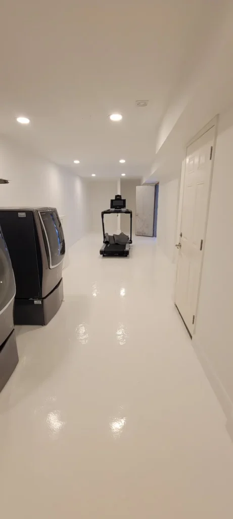 Finished laundry room remodel with epoxy flooring and washer dryer in El Sereno California