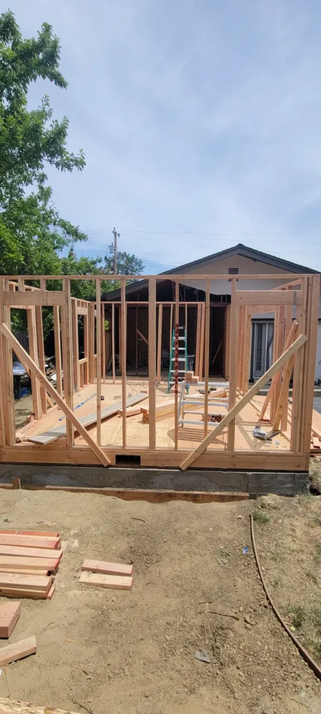 Wood framing for a master suite home addition in Martinez California showing structural walls for new bedroom and bathroom by Lions Gate Remodeling