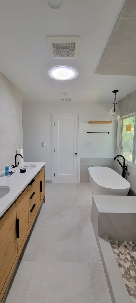 Completed master bathroom from a home addition in Martinez California with freestanding soaking tub, double vanity, and walk in shower by Lions Gate Remodeling