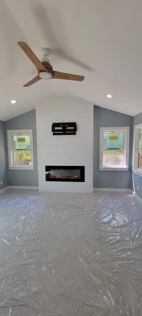 Finished master bedroom addition in Martinez California with vaulted ceiling, modern fireplace, and recessed lighting by Lions Gate Remodeling