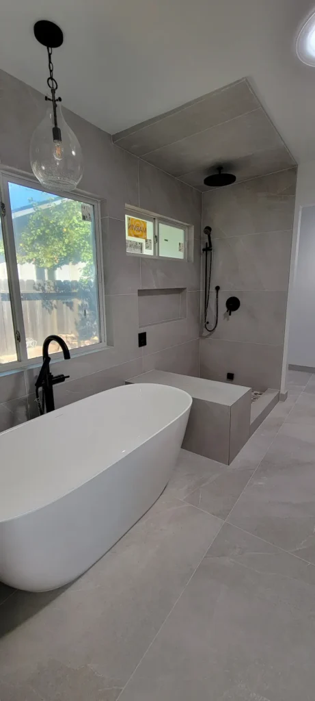 Luxury master bathroom addition in Martinez California featuring freestanding soaking tub and walk in shower with modern tile by Lions Gate Remodeling
