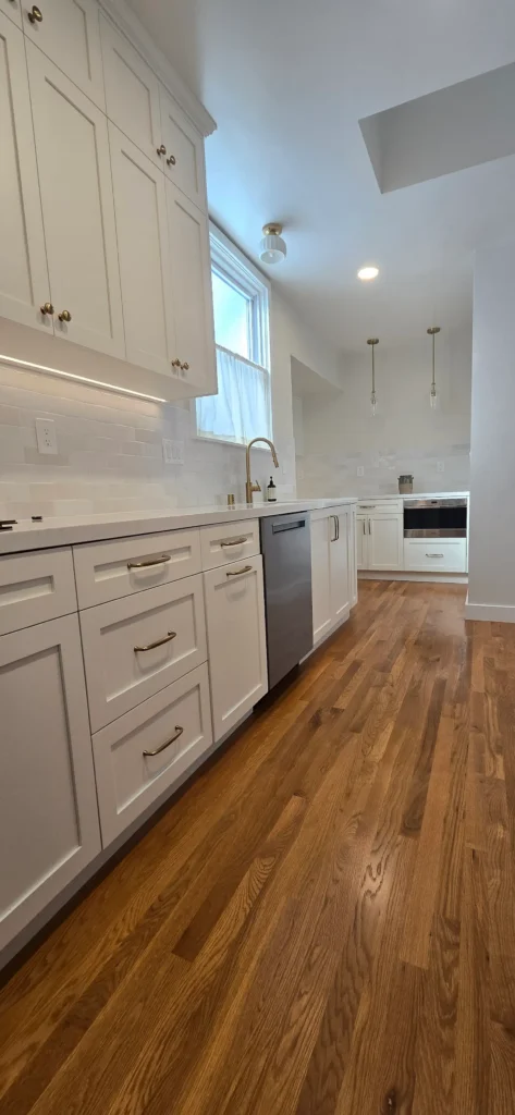 Finished Walnut Creek kitchen remodel with white shaker cabinets, brass hardware, quartz countertops, and hardwood flooring