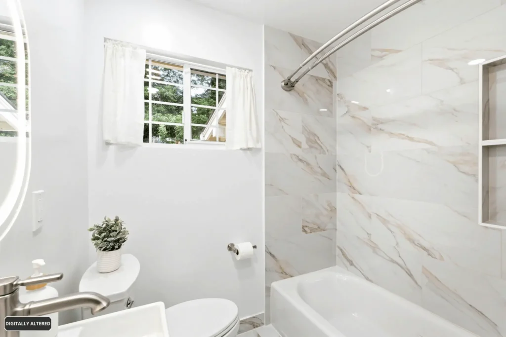 Large-format marble-look porcelain tile installed in a modern bathroom remodel.