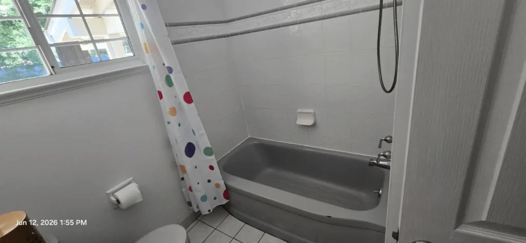 Before: Chipped tub in. this outdated Bathroom in Moraga, CA
